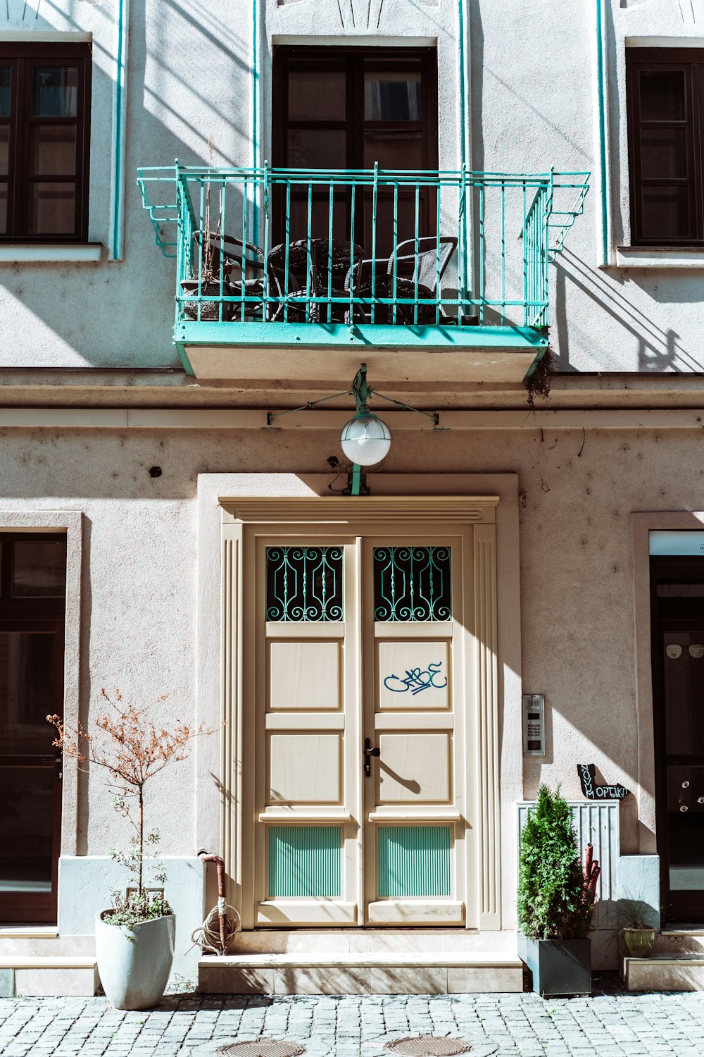 brown wooden door on white concrete building