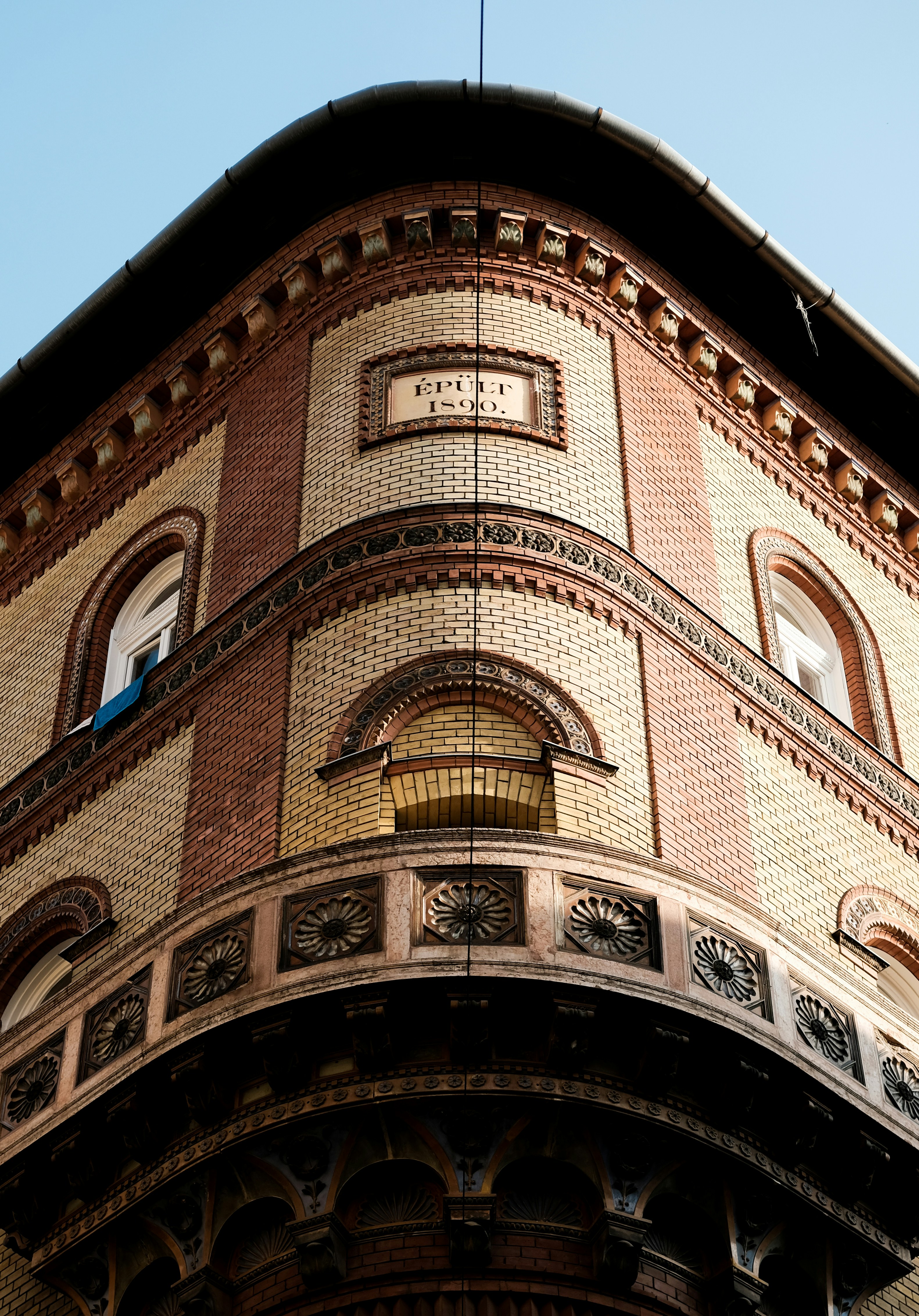 brown brick building under blue sky during daytime