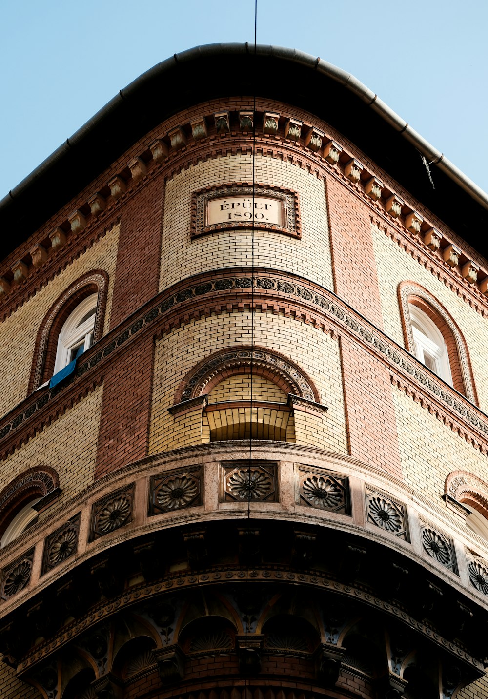 brown brick building under blue sky during daytime