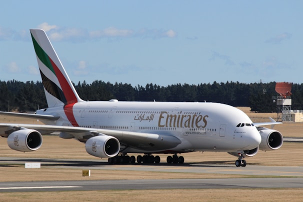 white and red passenger plane on airport during daytime