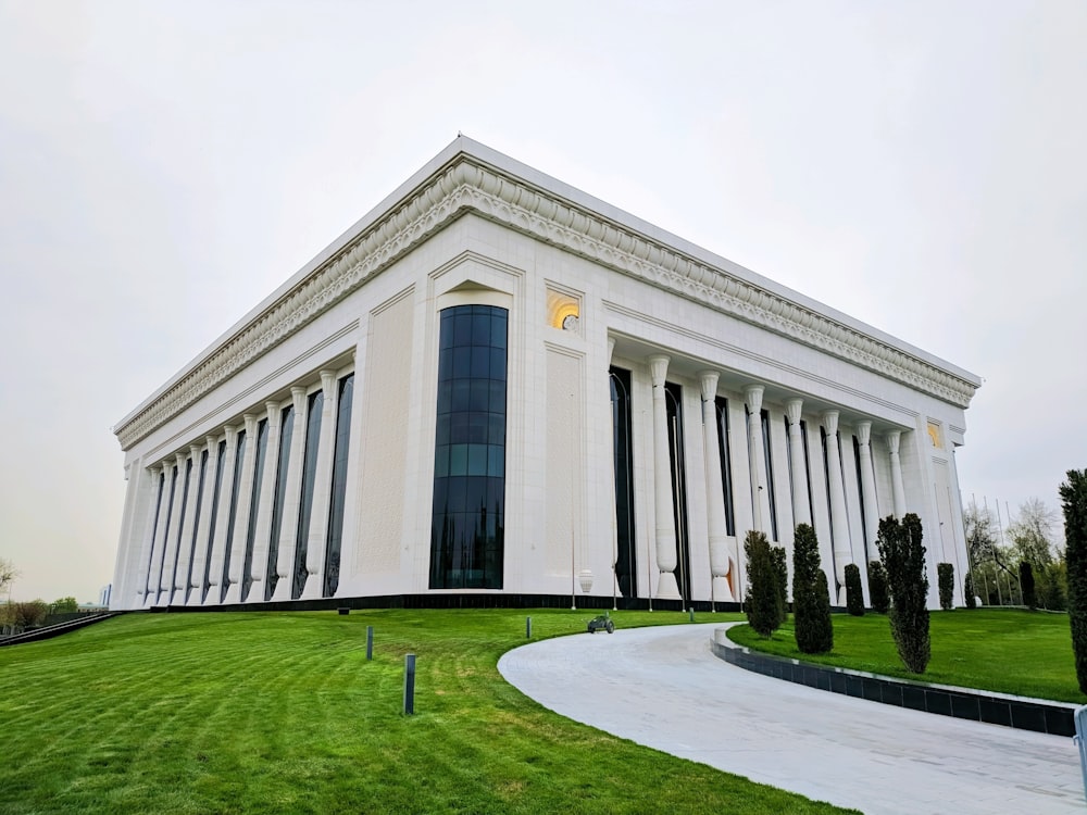 white concrete building with green grass field