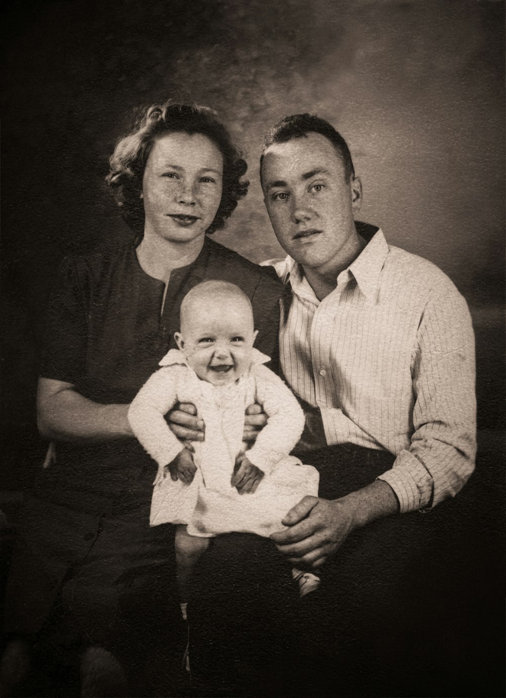 man in white dress shirt carrying baby in white dress