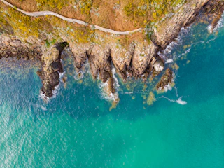 A coastal trail overlooking turquoise sea and cliffs