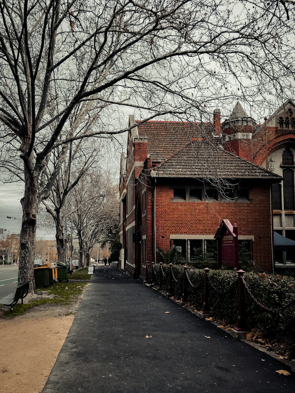 brown concrete building near bare trees during daytime