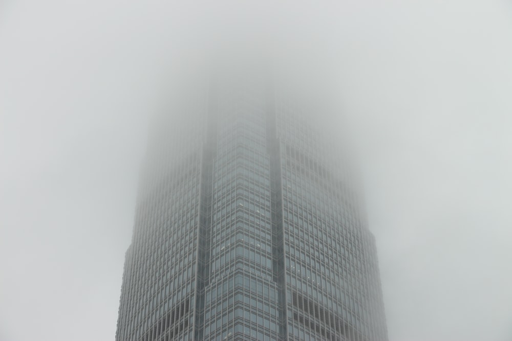 a very tall building with a lot of fog in the air