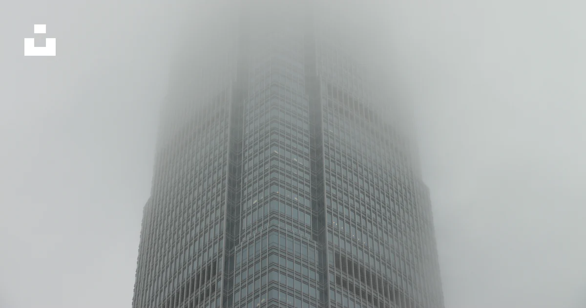 A very tall building with a lot of fog in the air photo – Free Grey ...