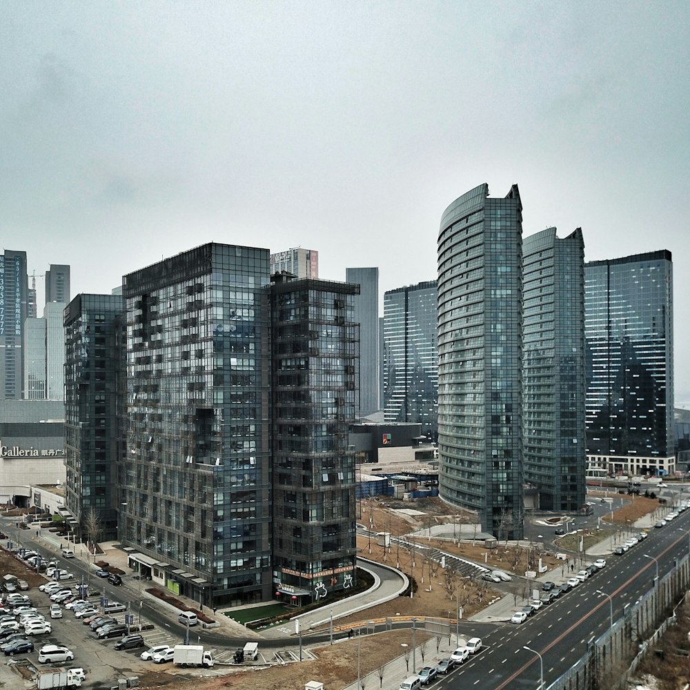 cars on road near city buildings during daytime