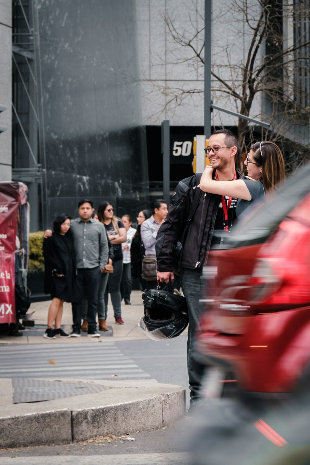 woman in black jacket standing beside black motorcycle during daytime