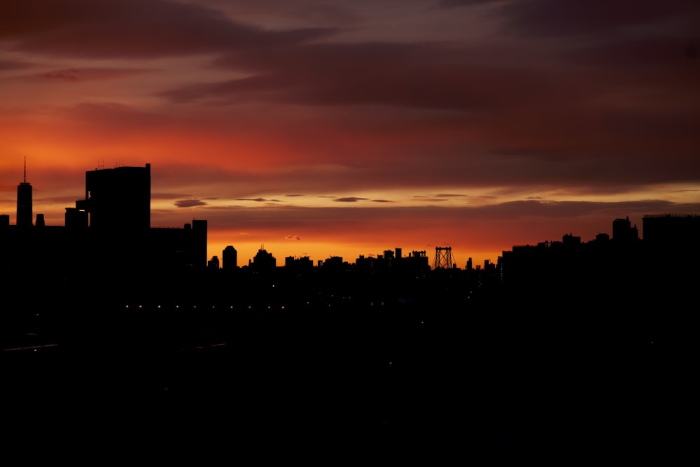 silhouette of city buildings during sunset