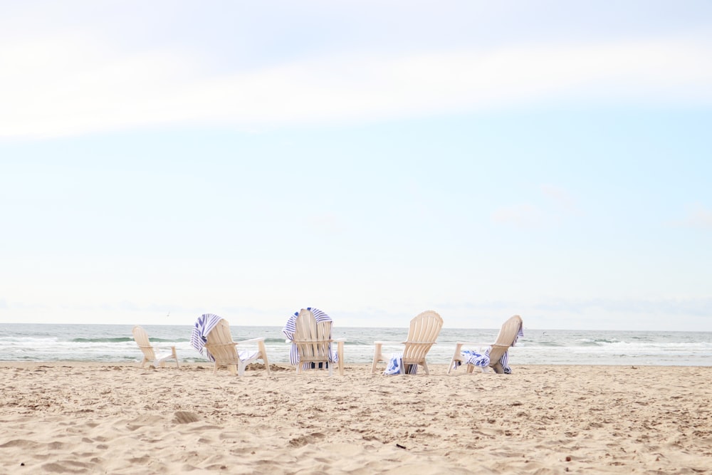 brown wooden umbrellas on beach during daytime