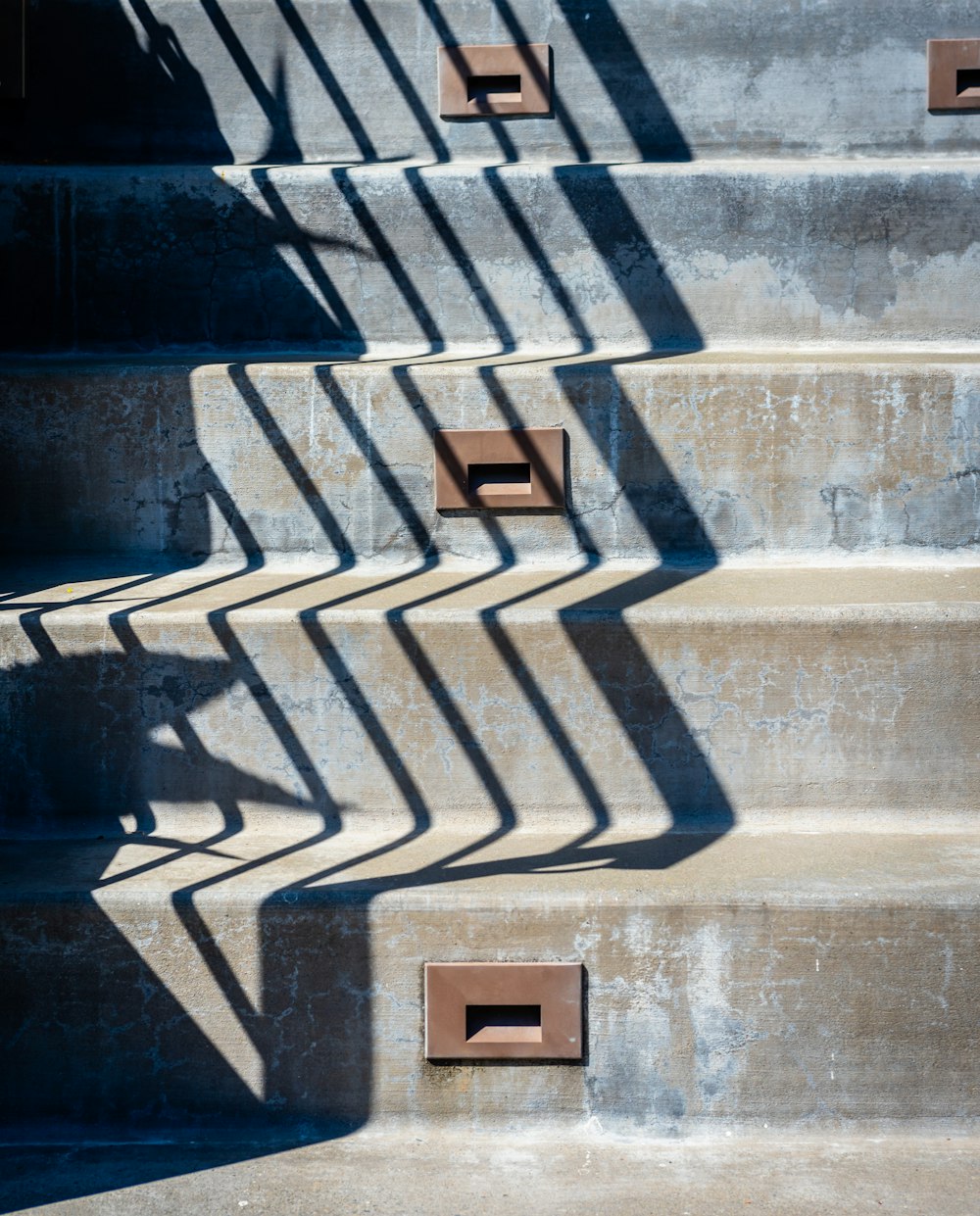 brown wooden box on gray concrete staircase