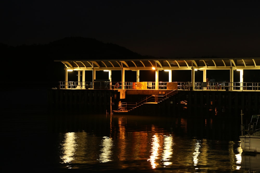 brown wooden house on body of water during night time