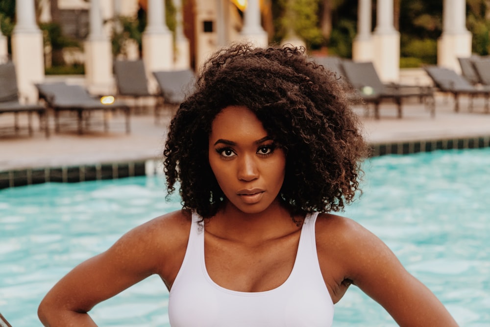 a woman standing in front of a swimming pool