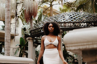 A confident woman wearing a sleek, high-waisted shaping faja in a bright, natural setting