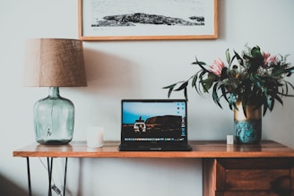 An elegant office table lamp placed on a wooden desk.