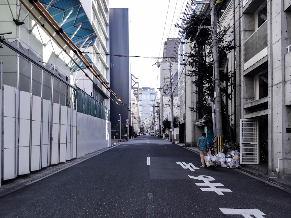 people walking on sidewalk near buildings during daytime