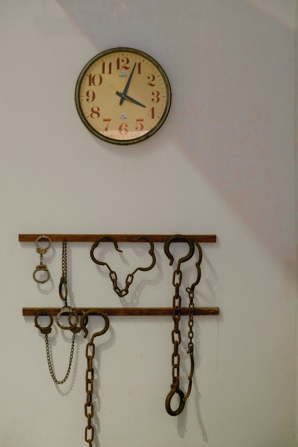 brown wooden framed analog wall clock at 10 00