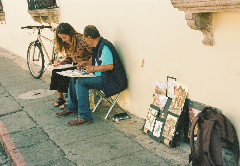 man and woman sitting on folding chairs