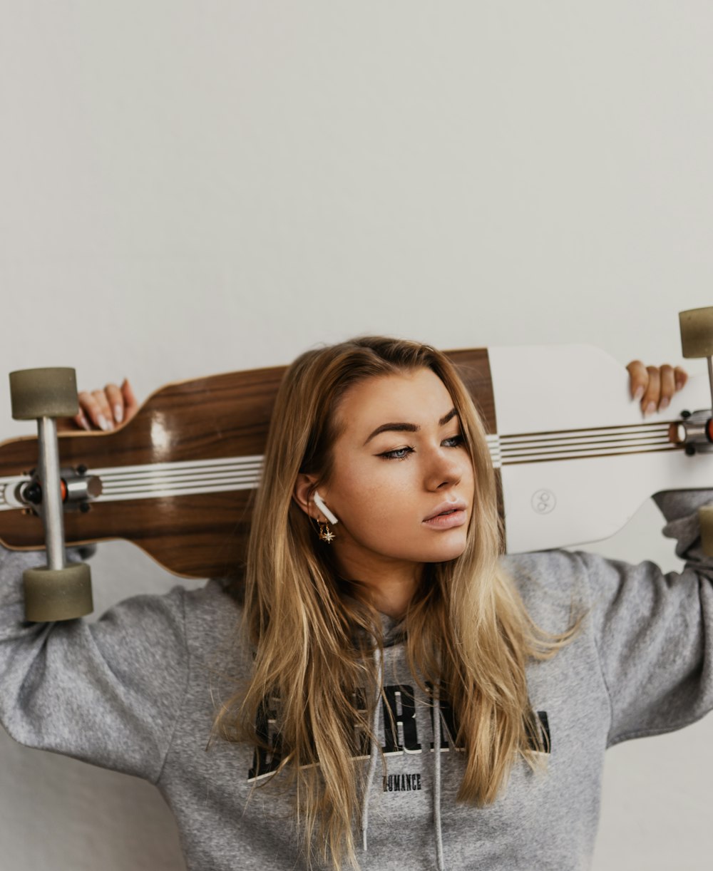 woman in gray hoodie sitting on bed