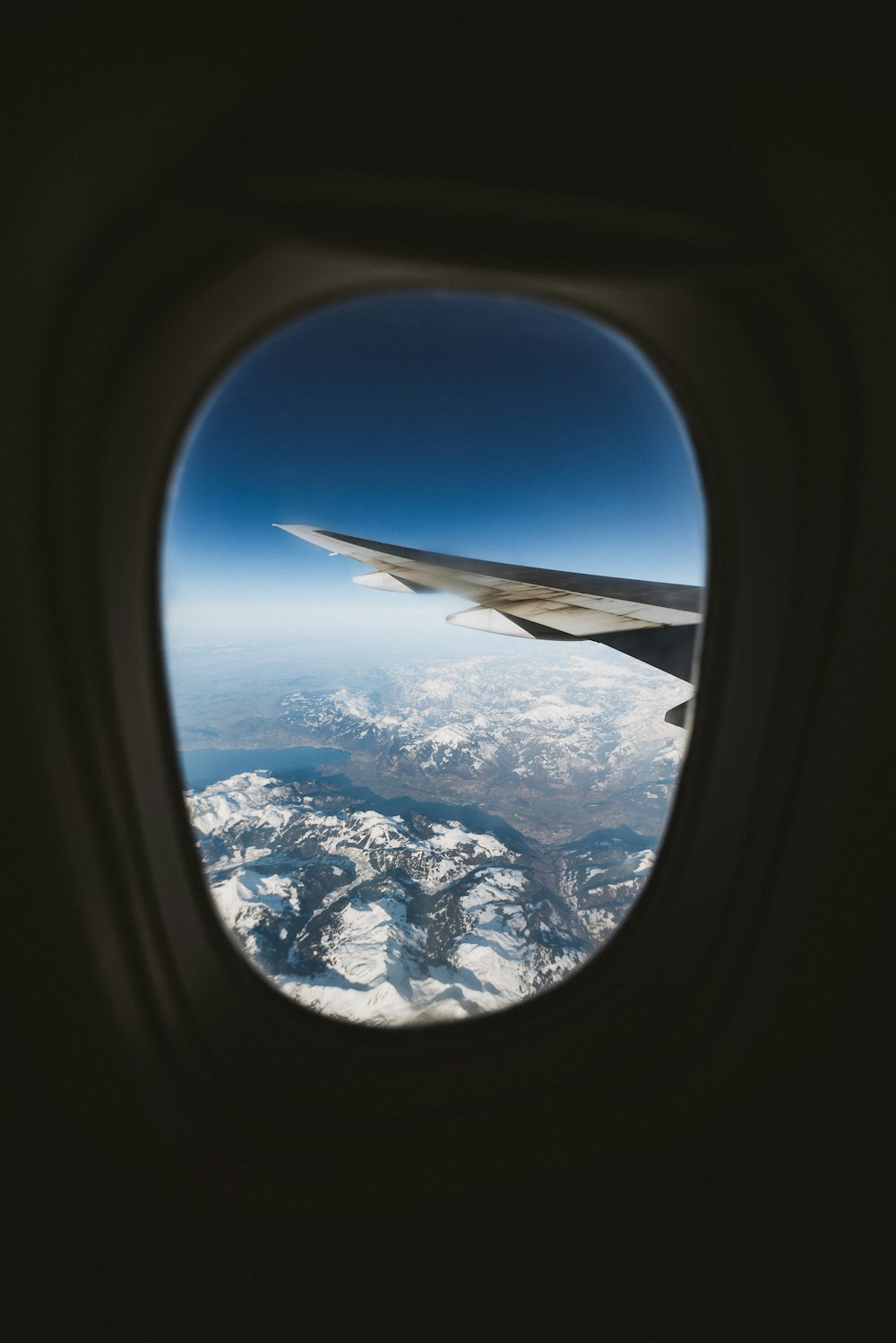 airplane window view of mountains during daytime