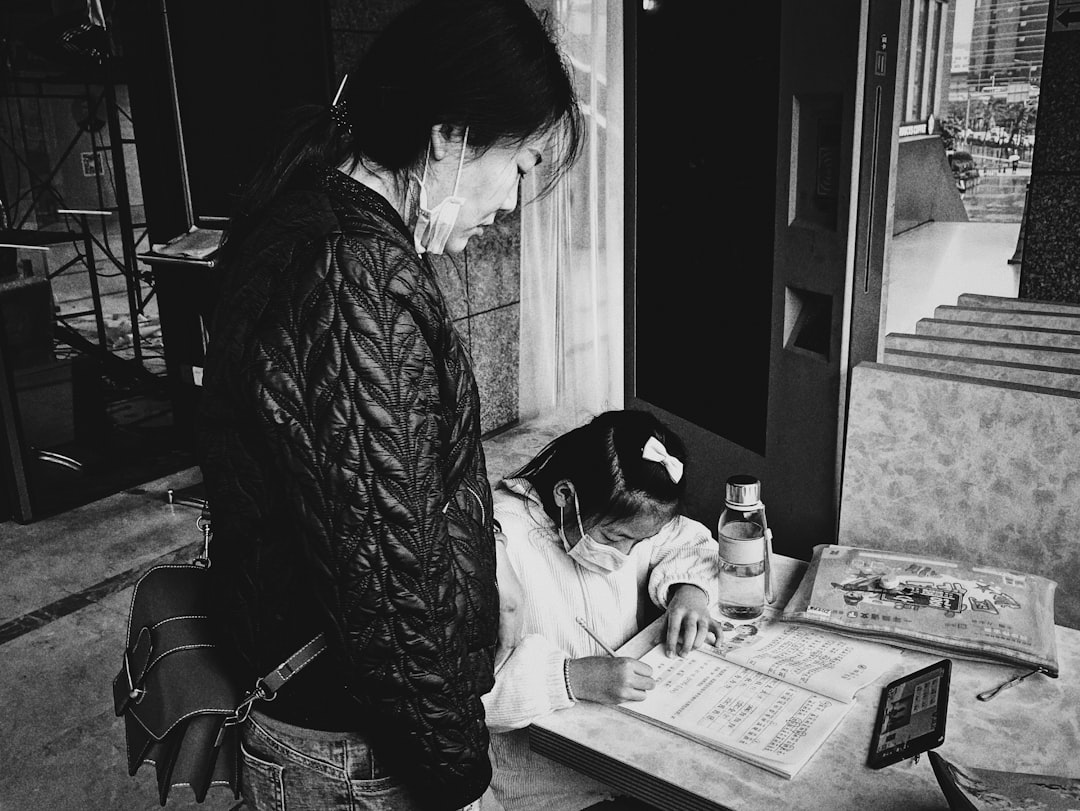 woman in black jacket reading newspaper