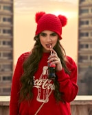 woman in red hoodie drinking coca cola