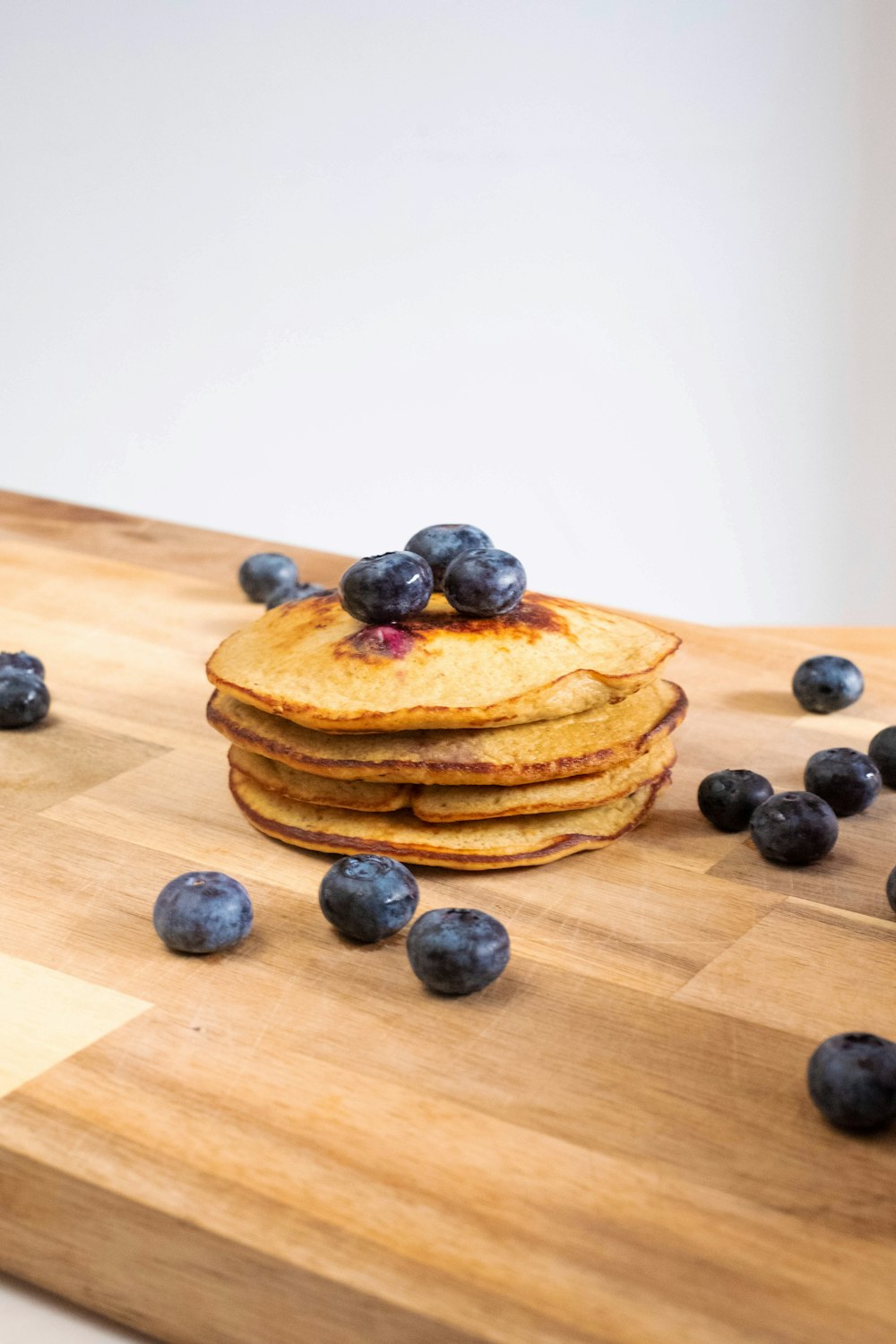 brown cookies with black berries on brown wooden table