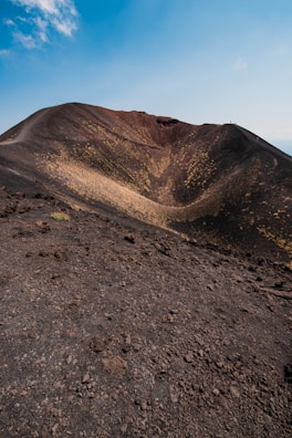 The dramatic crater rim of Ngorongoro with a clear blue sky overhead.