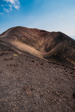 A dramatic volcanic crater on La Palma with rugged terrain under a clear blue sky.