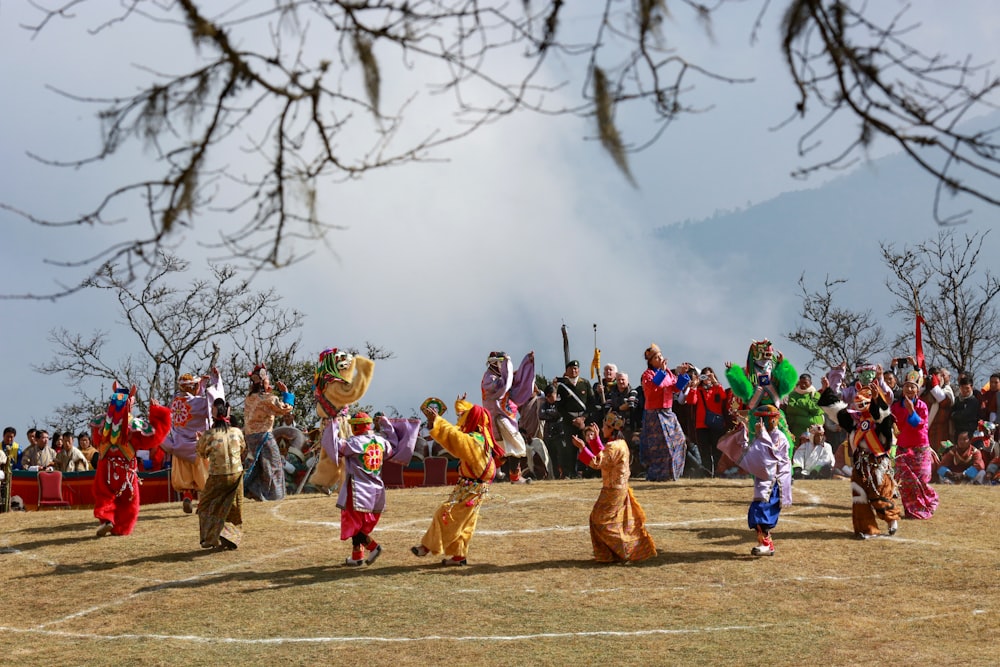 people in brown and blue costume standing on brown field during daytime