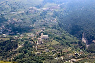 A panoramic shot of the valley below, dotted with traditional homes and terraced fields.