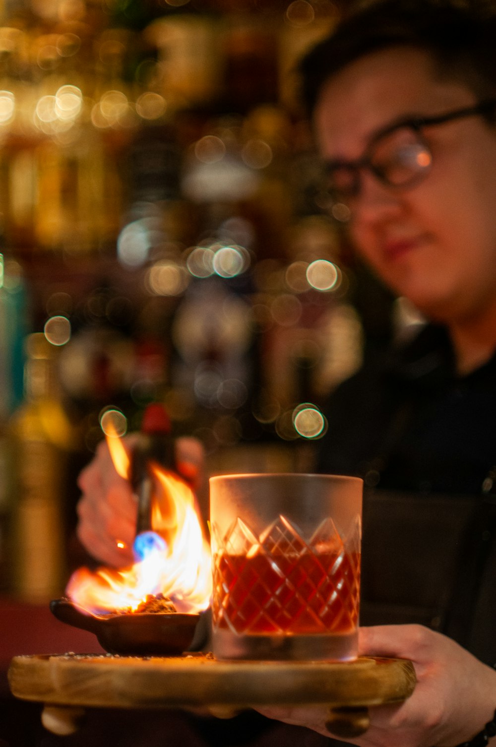 man in black shirt holding lighted candle