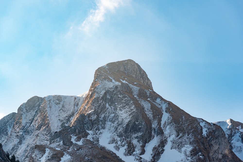 montanha coberta de neve sob o céu azul durante o dia