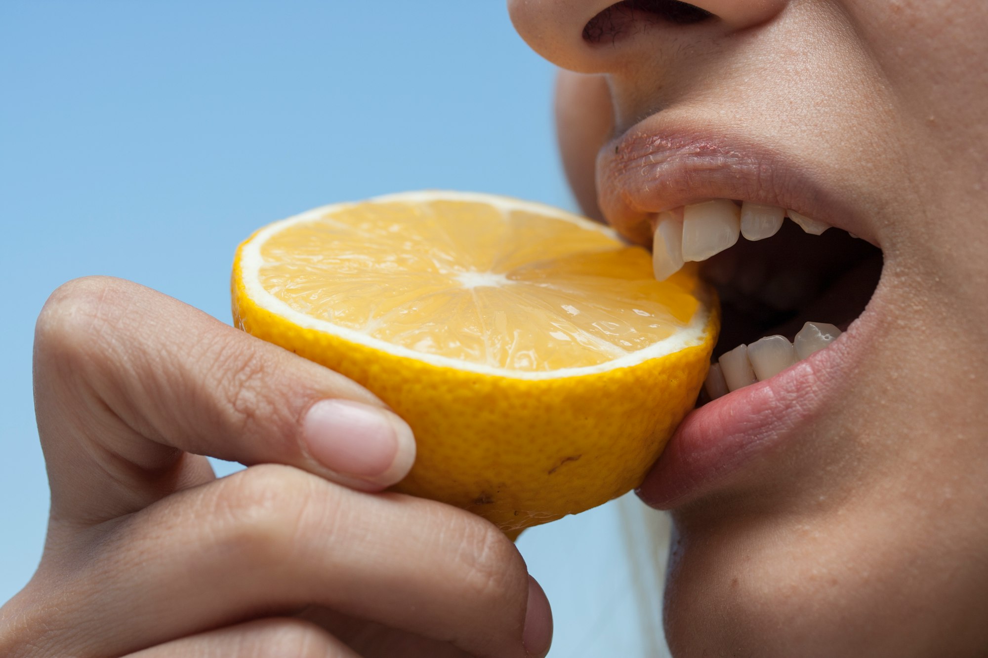 Woman Eating Lemon