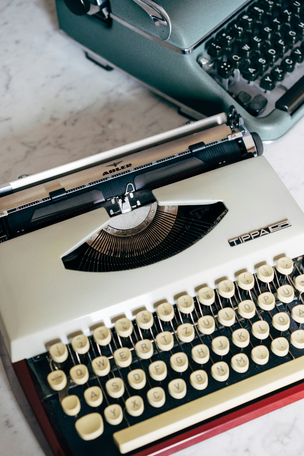 white and black typewriter on white table