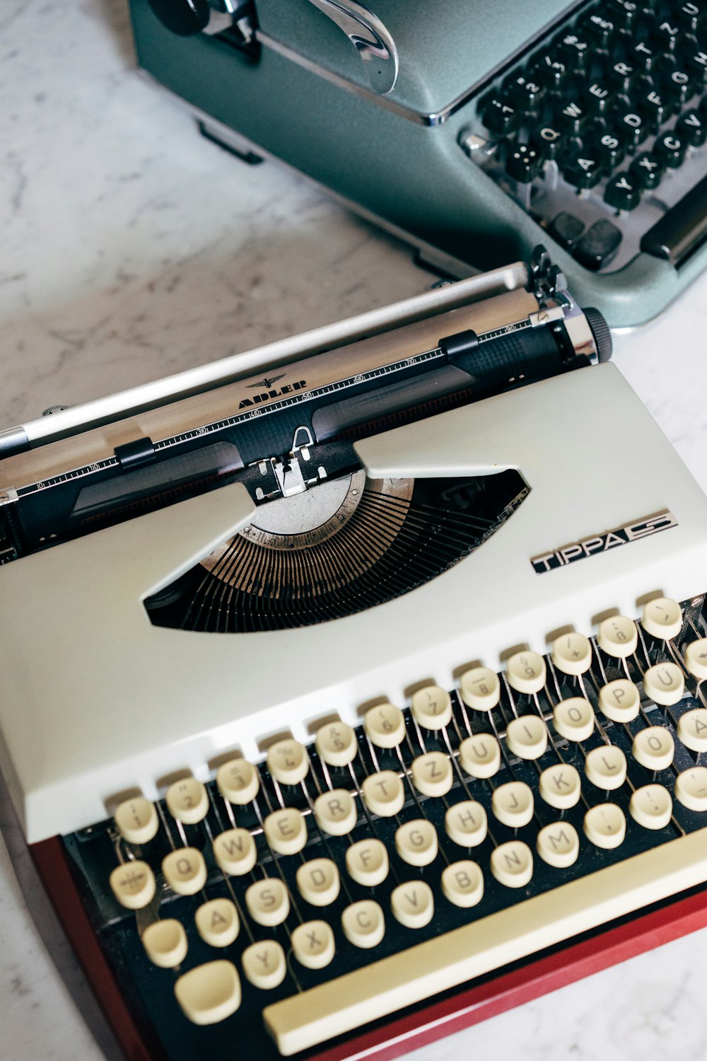 macchina da scrivere bianca e nera sul tavolo bianco