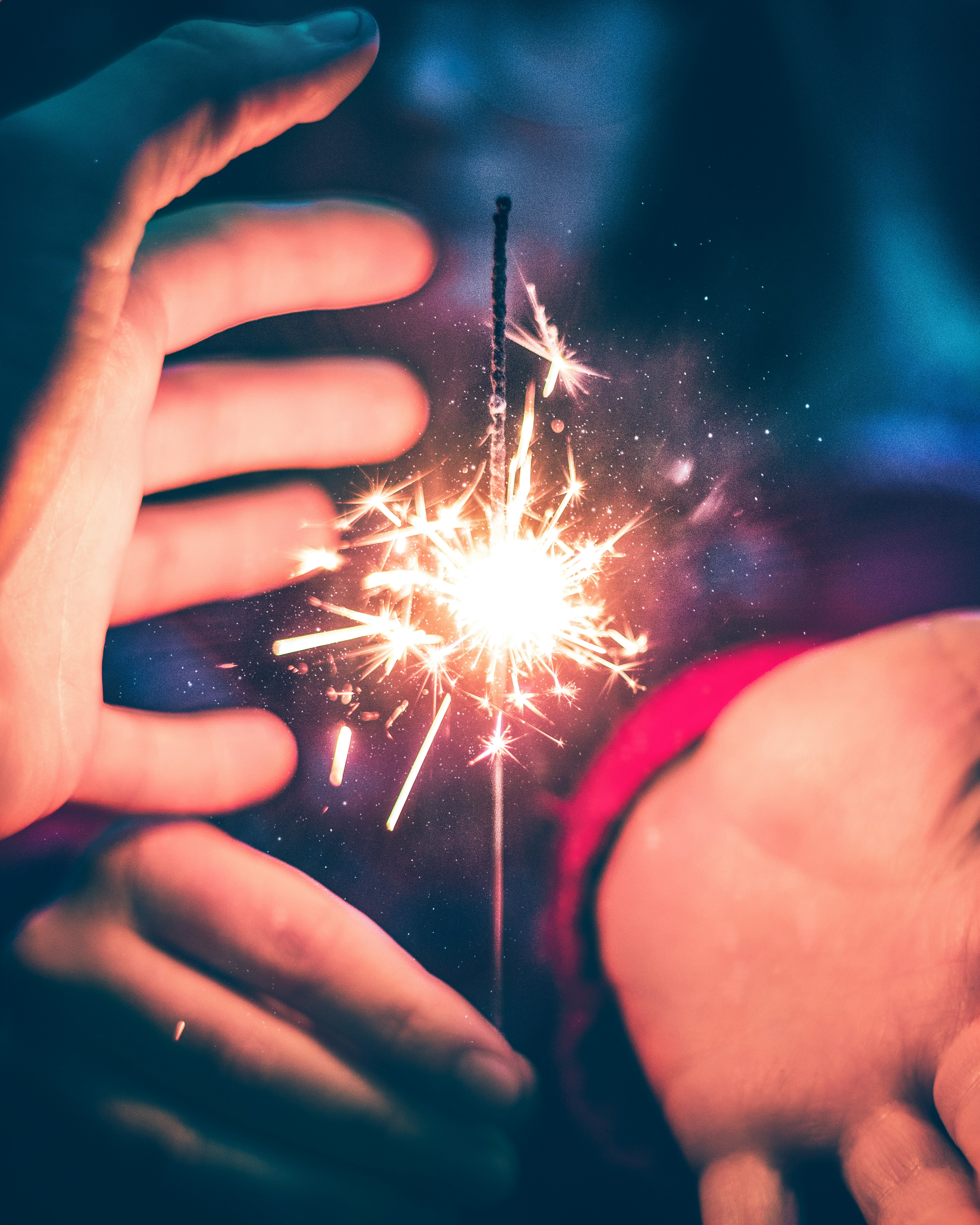 person holding white and red sparkler
