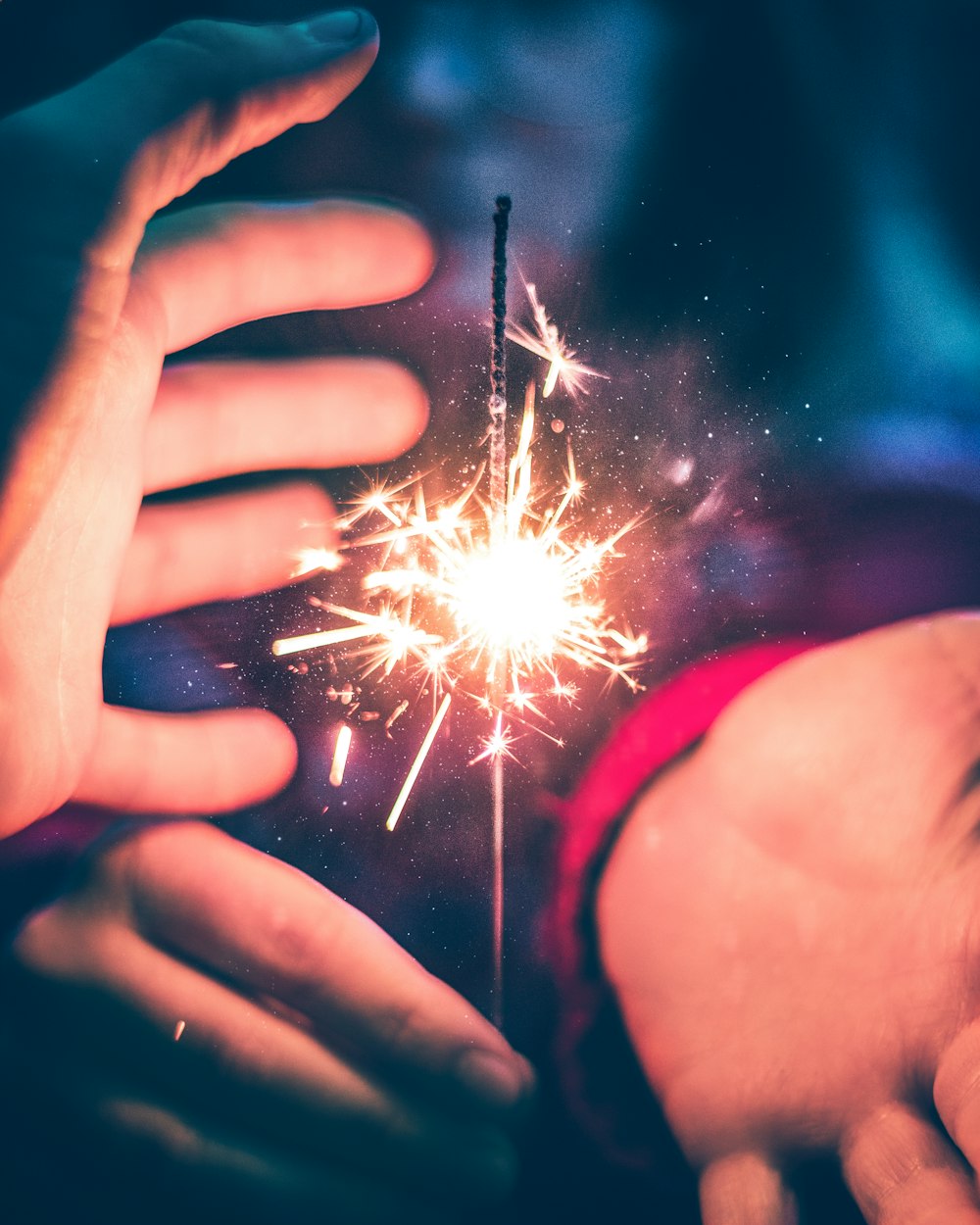person holding white and red sparkler