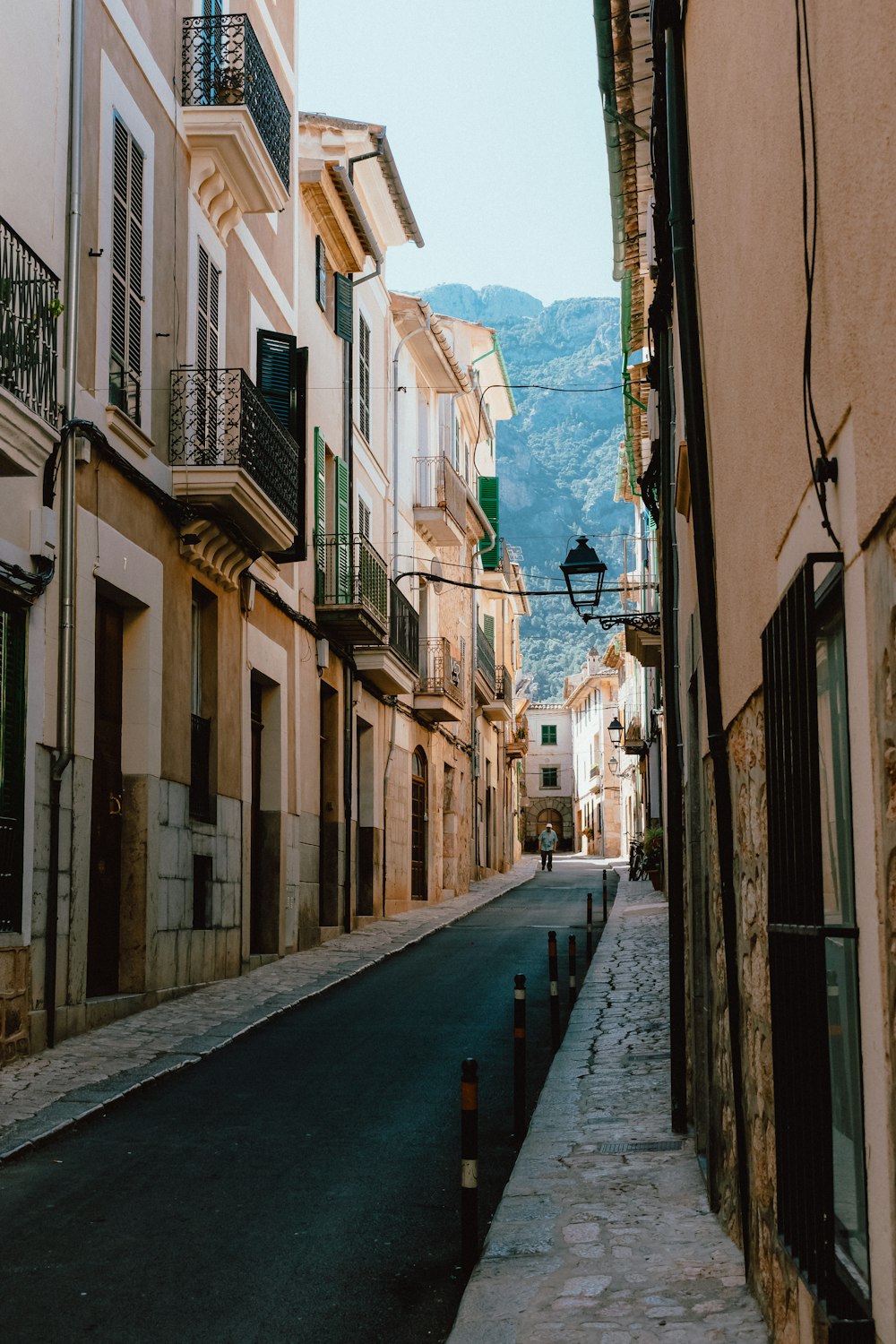 empty street between concrete buildings during daytime