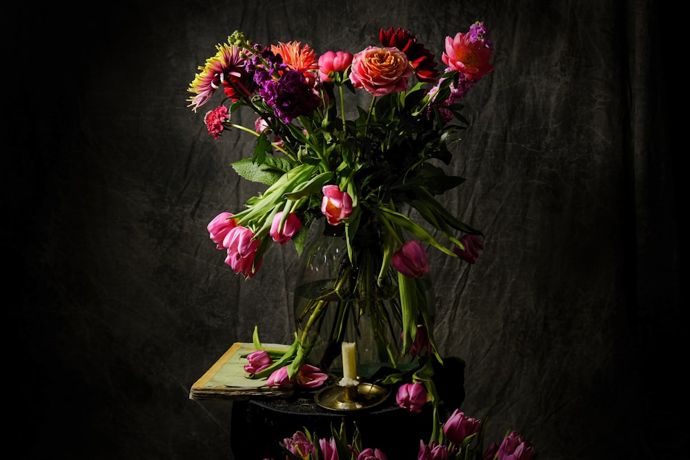pink and red flowers on brown wooden table