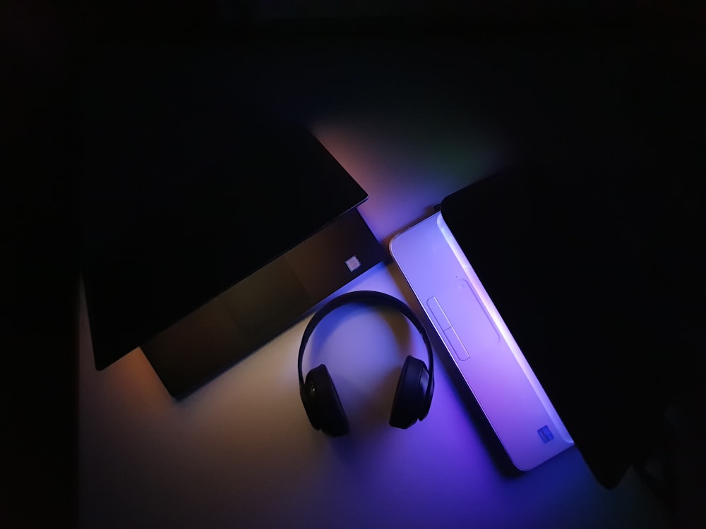 black and purple headphones on purple box