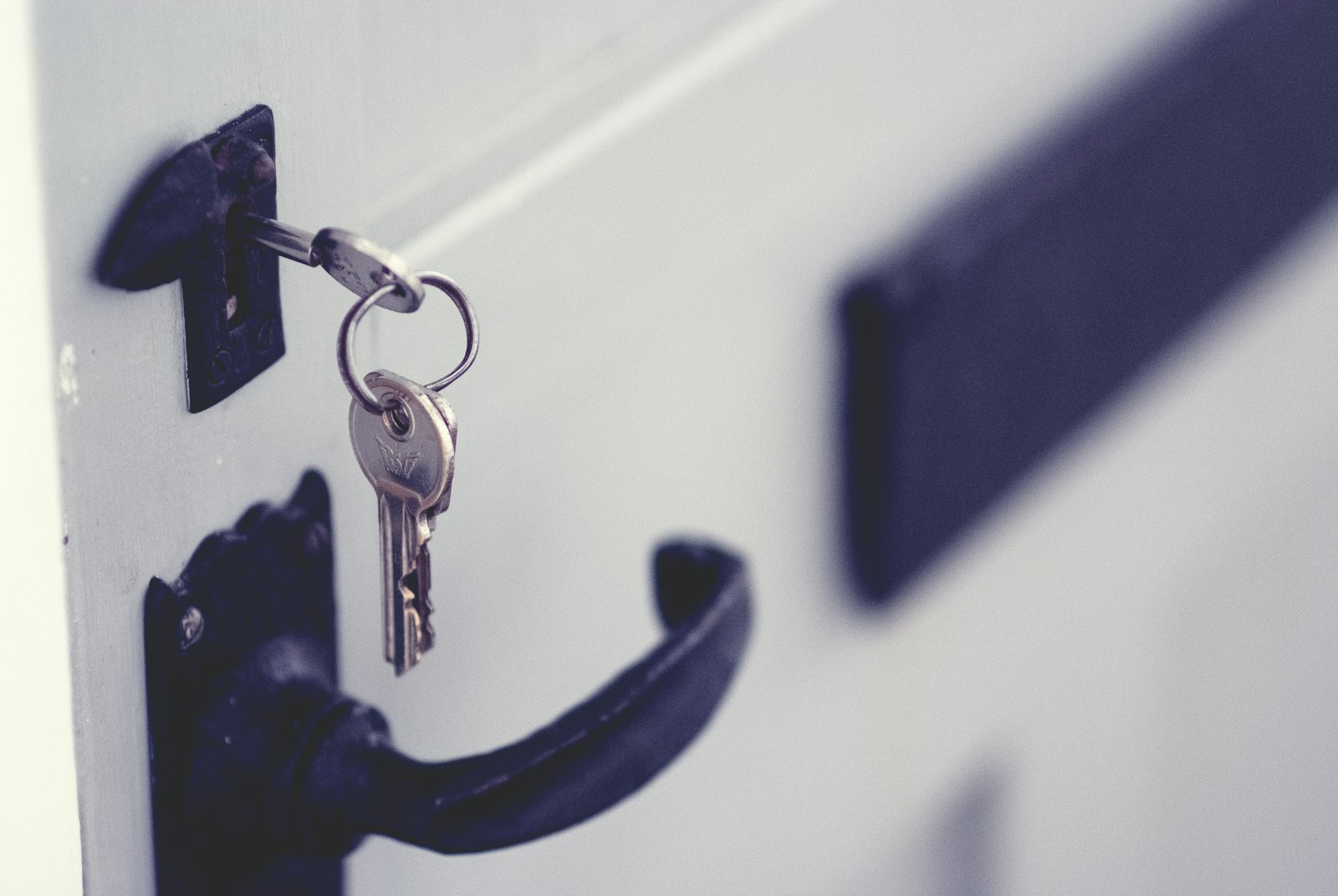 Close-up of a deadbolt lock and key installed on a front door