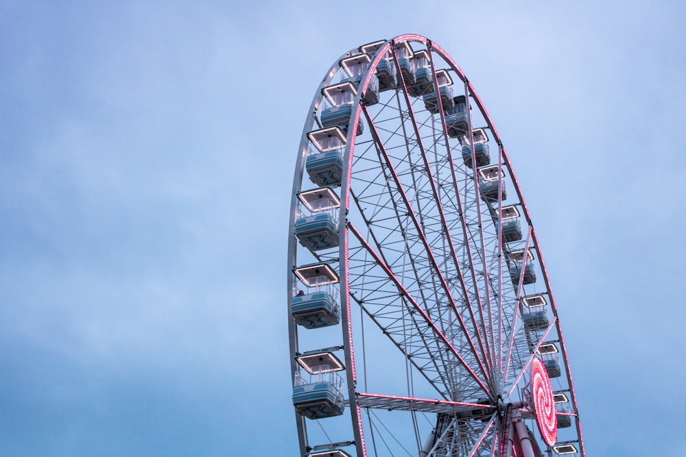 red and white ferris wheel under blue sky during daytime