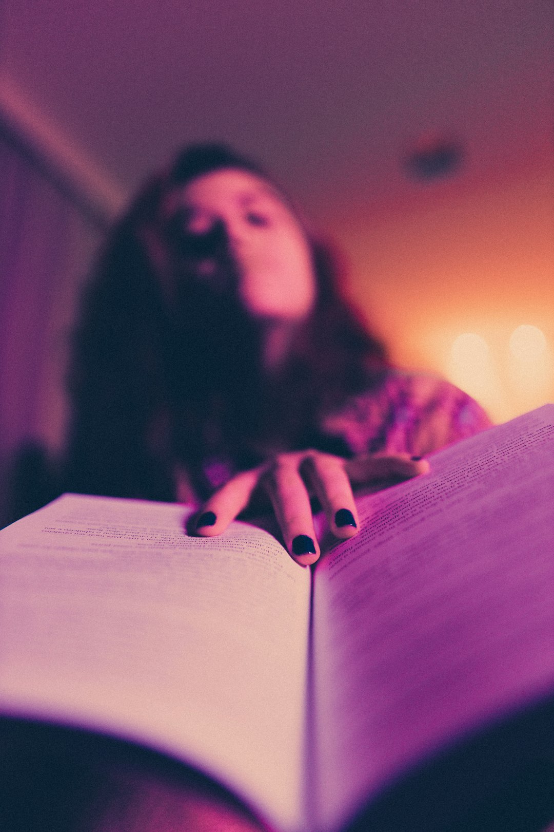 woman in black and gray shirt holding book