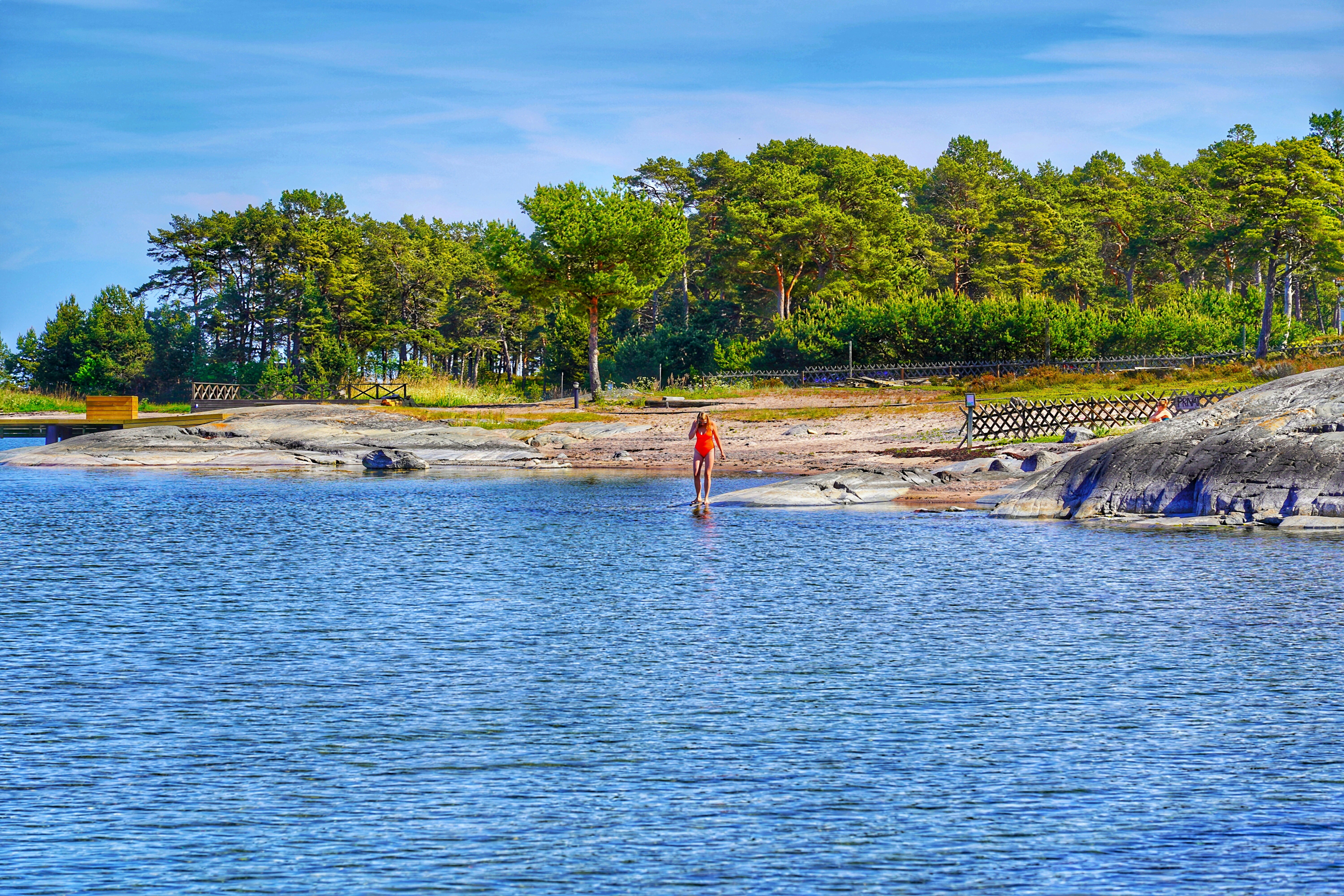 people swimming on lake during daytime