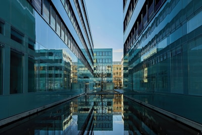 body of water between high rise buildings during daytime