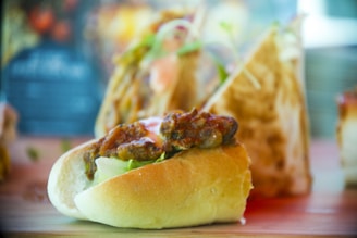 Close-up of a variety of fresh sandwiches and snacks on a wooden table.
