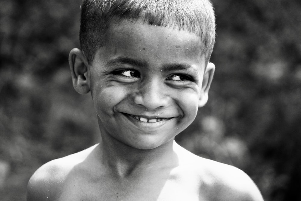 grayscale photo of smiling boy