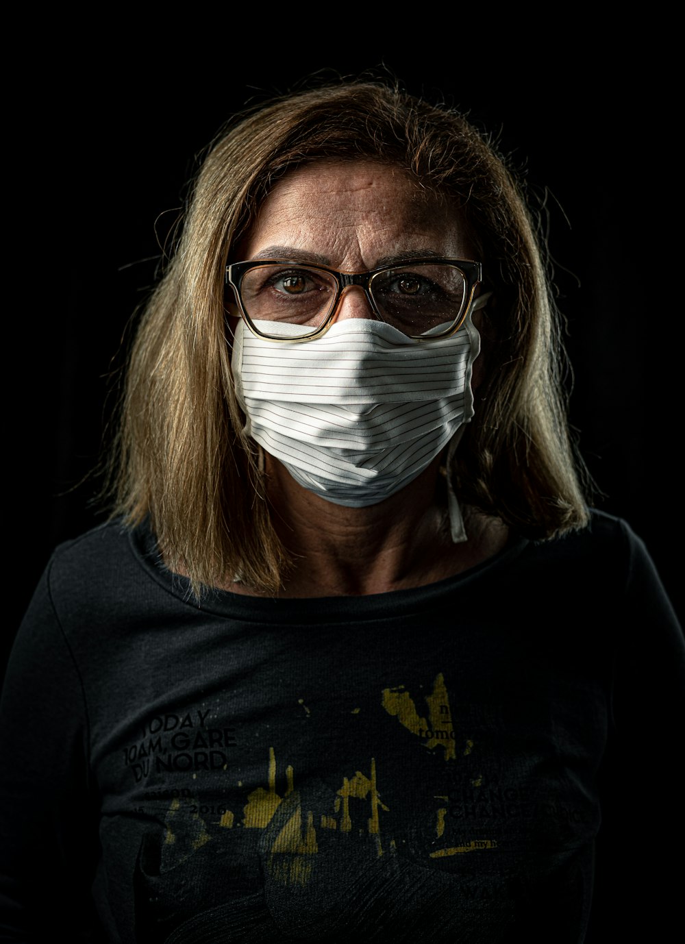 woman in black crew neck shirt with white face mask