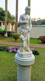 Marble statue symbolizing motherhood in a serene, elegant setting.